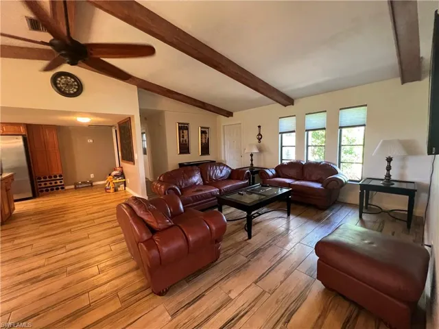 Living room with light wood-style flooring and ceiling fan