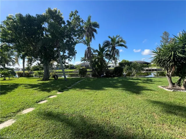 View of green lawn featuring a water view