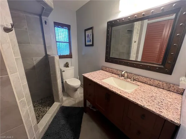 Full bathroom with vanity and a tile shower