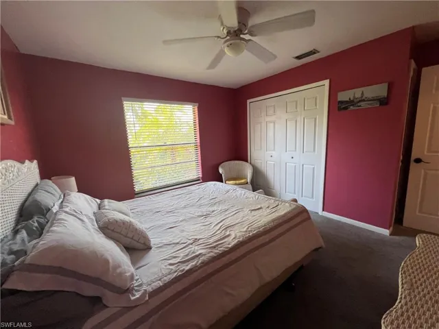 Bedroom featuring carpet, a closet, and ceiling fan