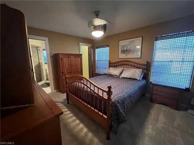 Carpeted bedroom featuring ceiling fan