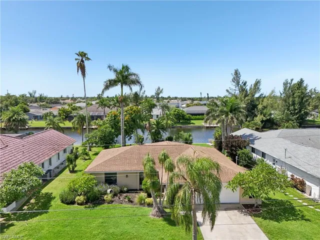 Aerial perspective of suburban area featuring a nearby body of water