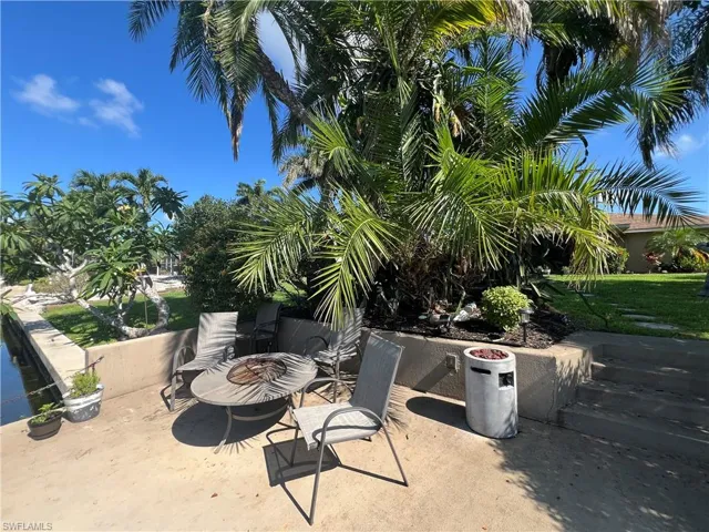 View of patio featuring an outdoor fire pit