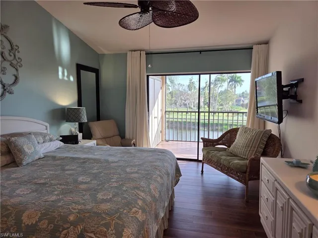 Bedroom featuring direct access to a screened balcony overlooking a tranquil water feature