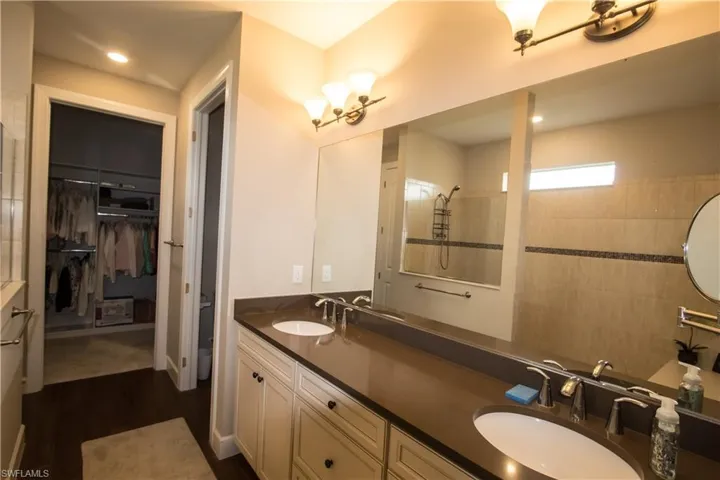 13'5"x9' bathroom with dual sink, large shower and walk-in closet