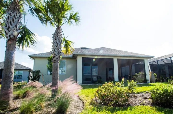Gorgeous landscaped back yard includes 3 mature palm trees
