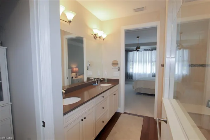 13'5"x9' bathroom with dual sink, large shower and walk-in closet