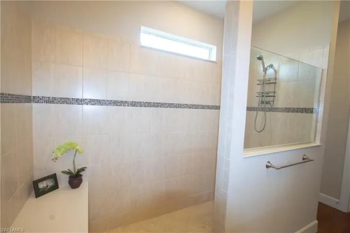 13'5"x9' bathroom with dual sink, large shower and walk-in closet
