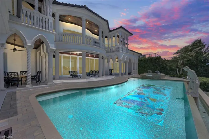 Pool at dusk with a patio area