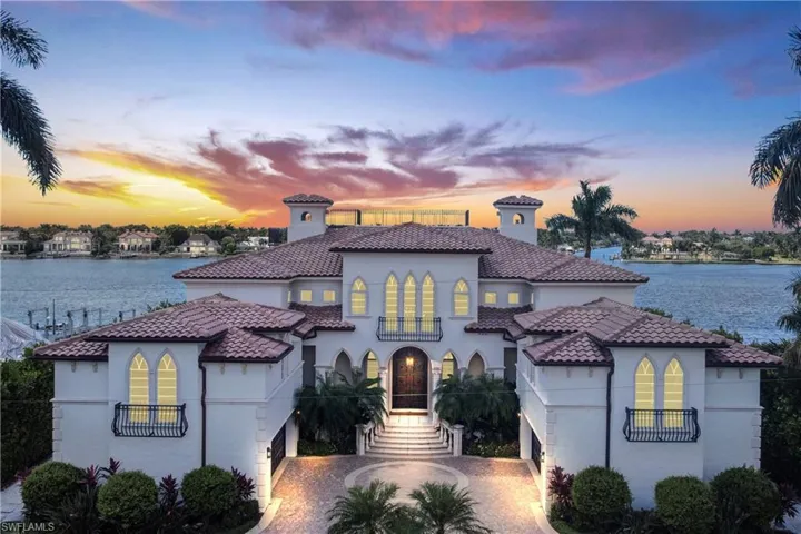 Mediterranean / spanish home with a water view