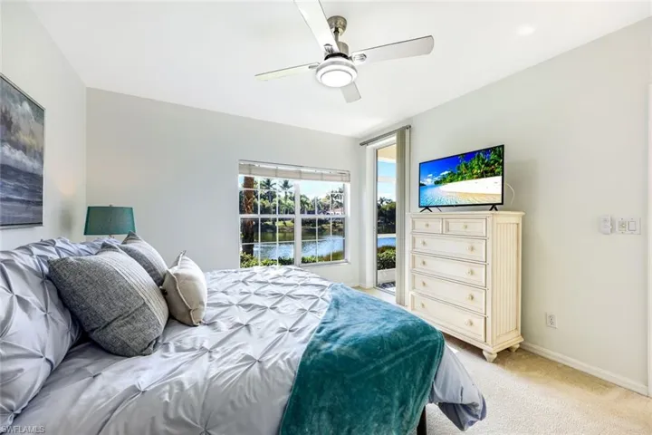 The primary bedroom suite overlooks the lake and offers lanai access.