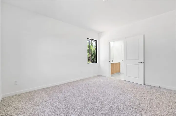 Unfurnished room with light carpet and baseboards