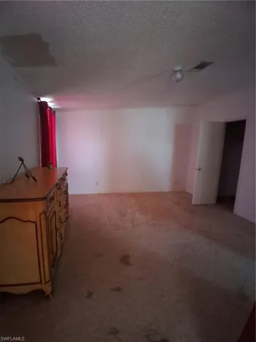 Finished below grade area featuring carpet and a textured ceiling