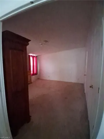 Hallway featuring carpet