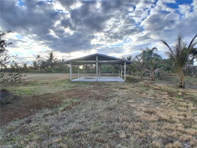 View of green lawn with a patio area