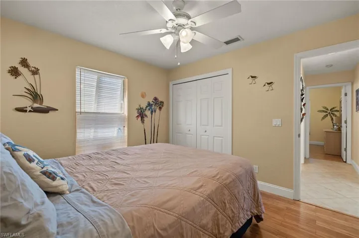 Bedroom featuring a closet, light hardwood / wood-style flooring, and ceiling fan
