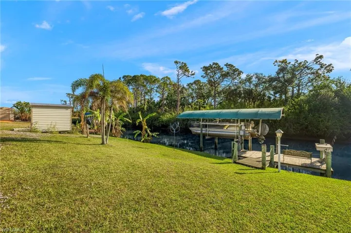 Dock area featuring a yard and a water view
