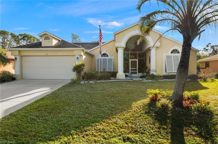 Single story home with a front lawn and a garage