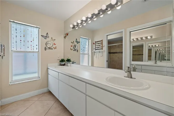 Bathroom with tile patterned flooring, vanity, and a shower with shower curtain