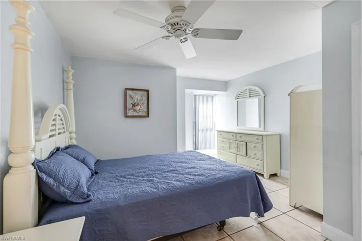 Bedroom featuring light tile patterned floors and ceiling fan