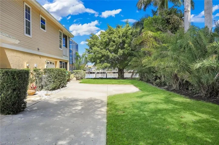 View of grassy yard with a water view