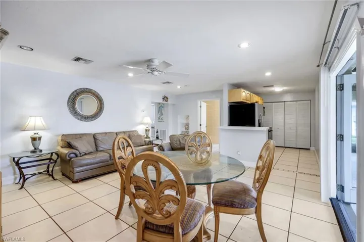 Dining space featuring light tile patterned floors, ceiling fan, and recessed lighting