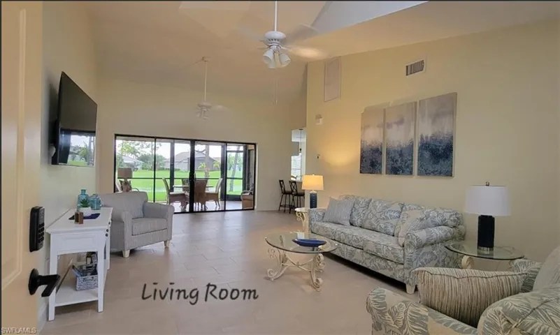 Living room featuring a ceiling fan, All NEW tile , and high vaulted ceiling