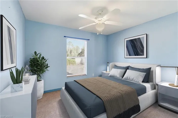 Carpeted bedroom featuring a ceiling fan