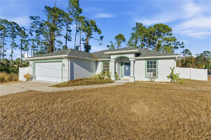 Single story home featuring stucco siding, driveway, an attached garage, and roof with shingles