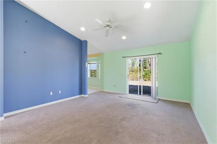 Carpeted spare room with recessed lighting, ceiling fan, and lofted ceiling