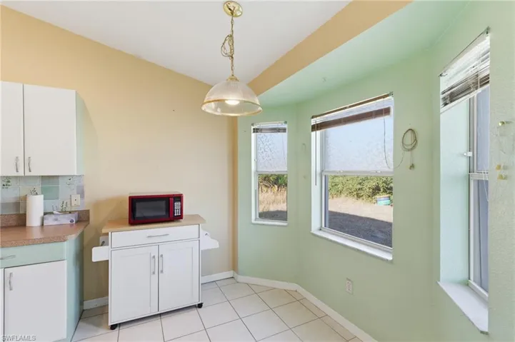 Dining room featuring baseboards and light tile patterned floors