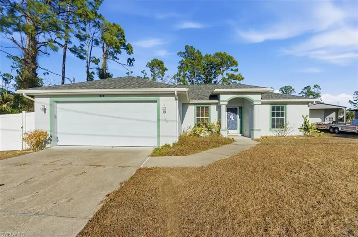 Single story home with stucco siding, driveway, roof with shingles, and an attached garage