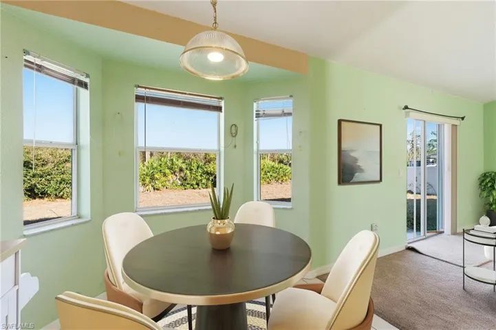 Carpeted dining area featuring healthy amount of natural light