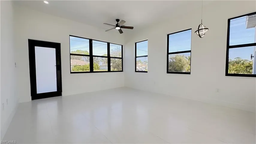 Empty room with a ceiling fan and baseboards