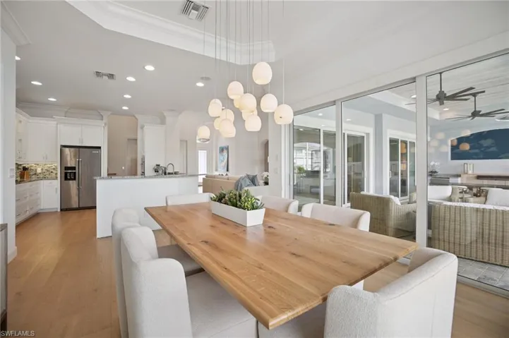 Dining area with crown molding, recessed tray ceiling and chandelier