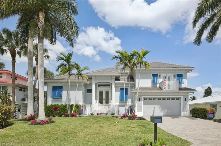 View of front of home featuring French doors, and attached 2 1/2 car garage with driveway