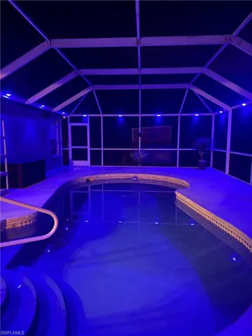 Pool at twilight with a sunroom