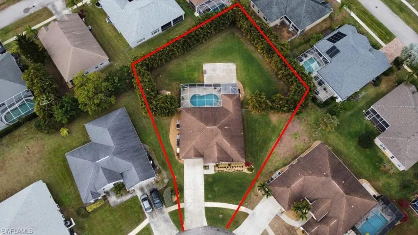 Aerial view of residential area with property parcel outlined