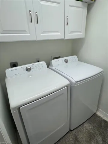 Laundry area featuring cabinet space and independent washer and dryer
