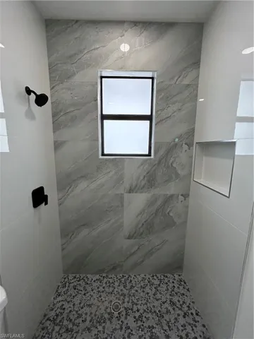 Full bathroom featuring a marble finish shower