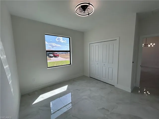 Unfurnished bedroom featuring baseboards and a closet