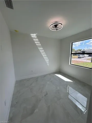 Empty room featuring baseboards