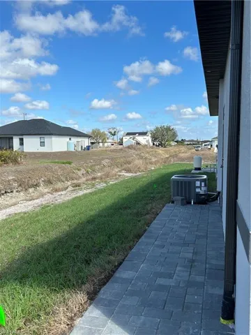 View of green lawn featuring a patio area