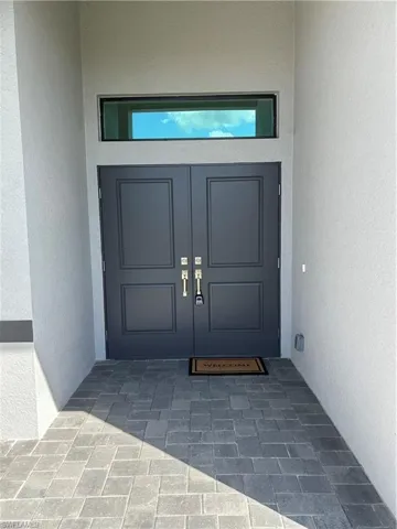 Property entrance featuring stucco siding