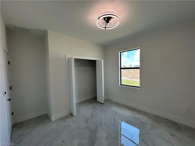 Unfurnished bedroom featuring baseboards and a closet