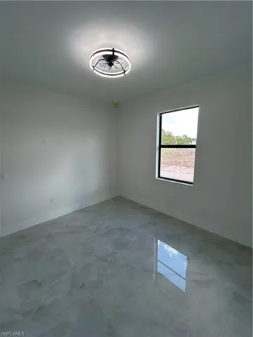 Unfurnished room with baseboards