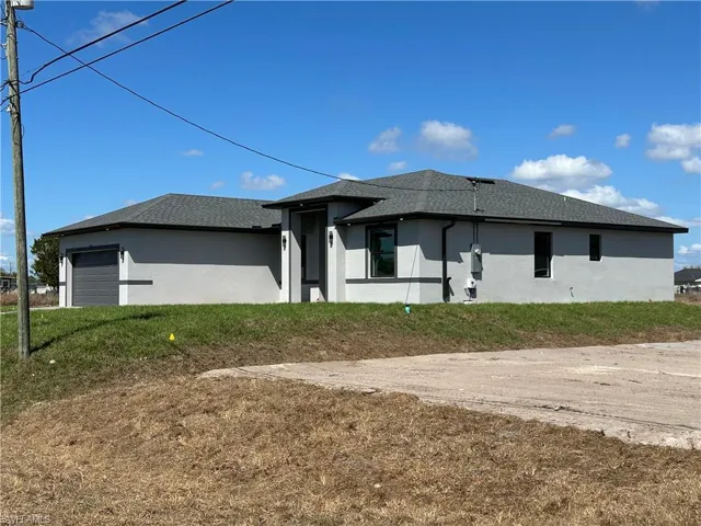 View of property exterior with stucco siding, a garage, and a shingled roof