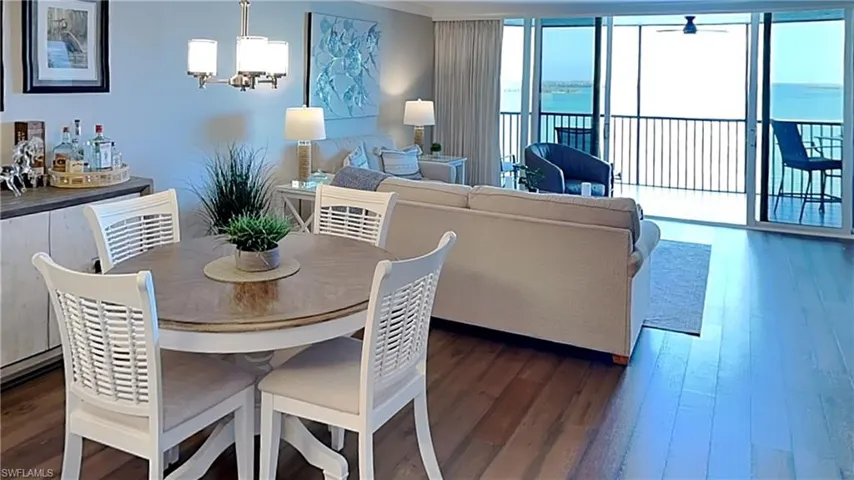 Open-concept living and dining area featuring wood-finish flooring