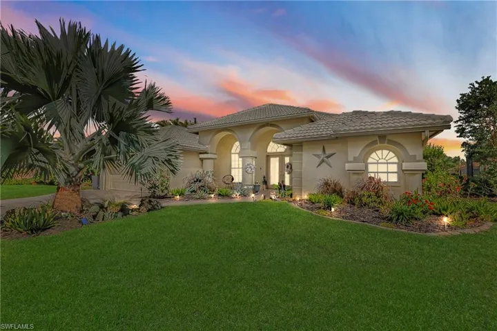 Mediterranean / spanish house with a garage and a yard