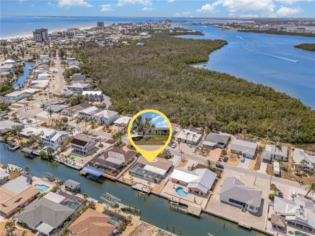 Aerial view of residential area featuring a nearby body of water